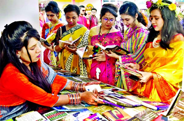 Bangla Academy Amar Ekushey Book Fair has taken a festive look with young girls clad in red and yellow attires on the first day of Pahela Falgun and Valentine's Day on Friday.