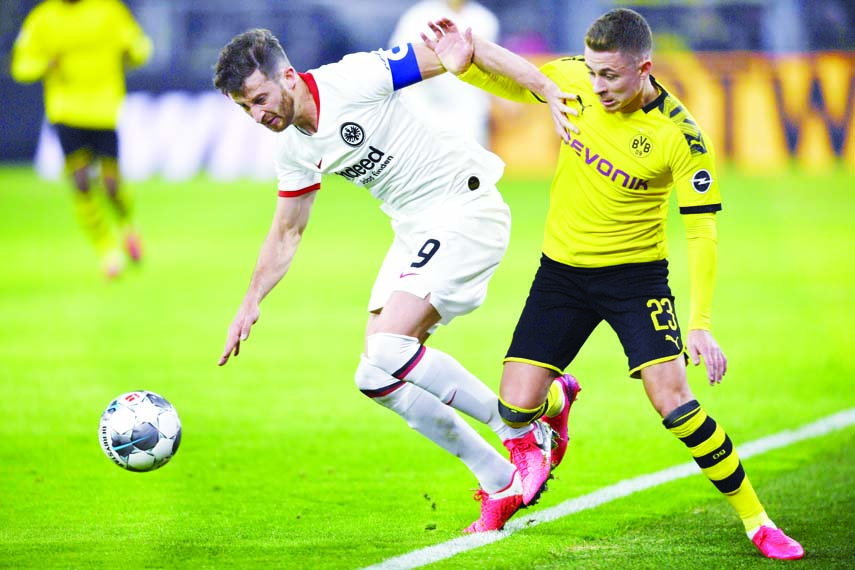 Frankfurt's David Abraham (left) and Dortmund's Thorgan Hazard challenge for the ball during the German Bundesliga soccer match between Borussia Dortmund and Eintracht Frankfurt at Dortmund in Germany on Friday.