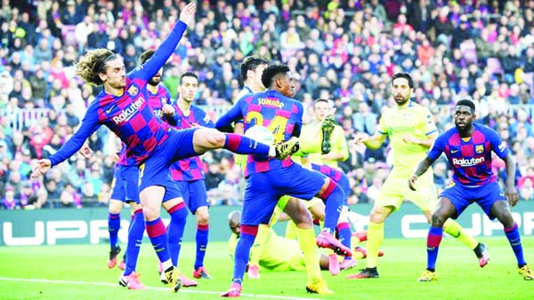 Barcelona's French forward Antoine Griezmann (left) kicks the ball during the Spanish League football match between FC Barcelona and Getafe CF at the Camp Nou stadium in Barcelona, Spain on Saturday.