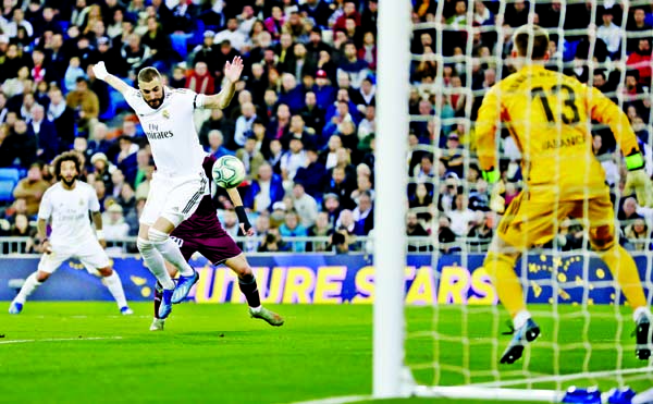 Real Madrid's Karim Benzema fights for the ball during the Spanish La Liga soccer match between Real Madrid and Celta de Vigo at the Santiago Bernabeu stadium in Madrid, Spain on Sunday.