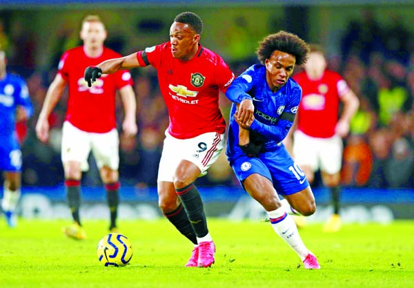 Manchester United's Anthony Martial (left) and Chelsea's William battle for the ball during the English Premier League soccer match between Chelsea and Manchester United at Stamford Bridge in London of England on Monday.