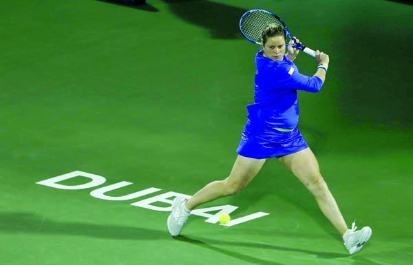 Belgium's Kim Clijsters returns the ball to Spain's Gabrine Muguruza during a match of the Dubai Duty Free Tennis Championship in Dubai, United Arab Emirates on Monday.