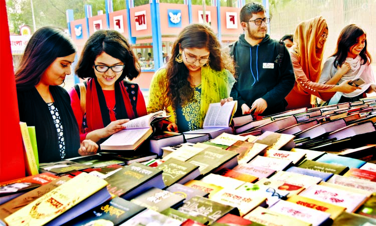 Book lovers browse at a stall on the seventeenth day of Amar Ekushey Boi Mela on Bangla Academy premises in Dhaka on Tuesday.