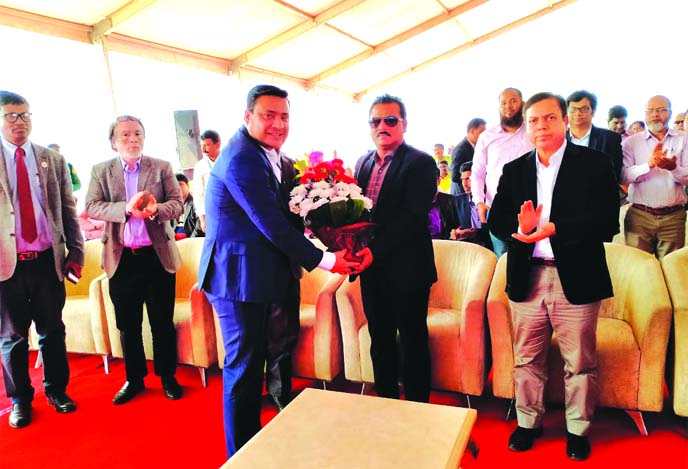 High officials from PowerPac Holdings and Shikder Group, congratulating to the State Minister for Housing and Public Works Sharif Ahmed with flower bouquet during his visit to under construction Bangabondhu Iconic Tower at Purbachol Central Business Distr