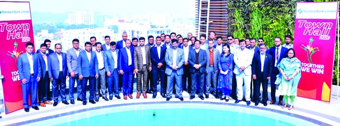 Khondoker Rashed Maqsood, Managing Director of Standard Bank Limited, pose for a photo session at the Town Hall Meeting-2020 of at a hotel in Chattogram recently. Md. Tariqul Azam, AMD, Alkona K Choudhuri, Head of HRD and Ali Reza, CFO of the bank, were a