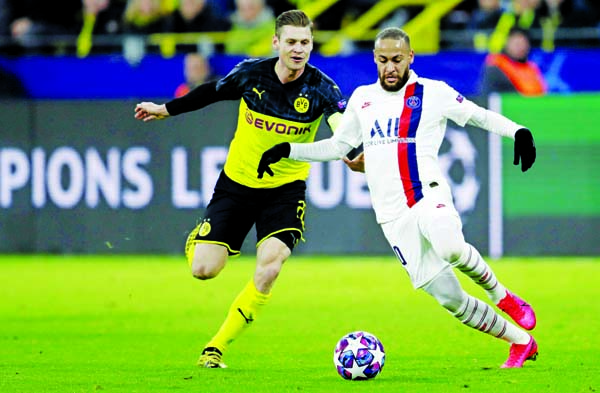PSG's Neymar (right) duels for the ball with Dortmund's Lukasz Piszczek during the Champions League round of 16 first leg soccer match between Borussia Dortmund and Paris Saint Germain (PSG) at Dortmund in Germany on Tuesday.
