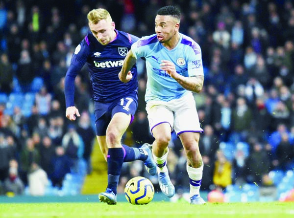 Manchester City's Gabriel Jesus takes the ball away from West Ham's Jarrod Bowen (left) during the English Premier League soccer match between Manchester City and West Ham at Etihad stadium in Manchester of England on Wednesday.