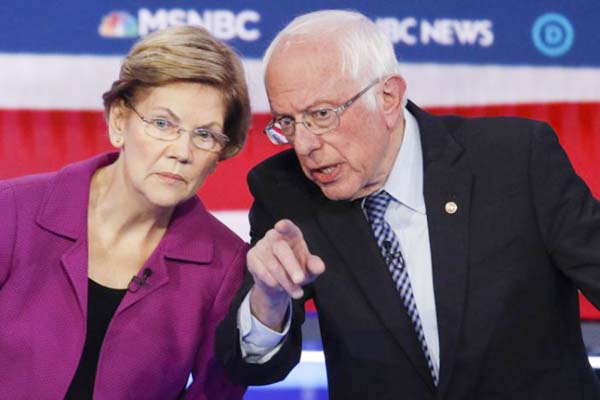 Democratic Presidential candidates, Sen. Elizabeth Warren, D-Mass., (left) and Sen. Bernie Sanders, I-Vt., talk during a Democratic Presidential primary debate on Wednesday in Las Vegas