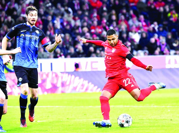 Munich's Serge Gnabry (right) scores the opening goal during the German Bundesliga soccer match between Bayern Munich and SC Paderborn 07 in Munich of Germany on Friday.