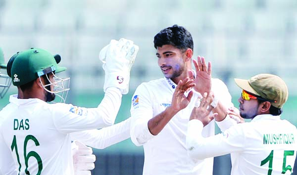 Nayeem Hasan (center) of Bangladesh, celebrates a wicket of Zimbabwe during the first day of the lone Test match between Bangladesh and Zimbabwe at the Sher-e-Bangla National Cricket Stadium in the city's Mirpur on Saturday.