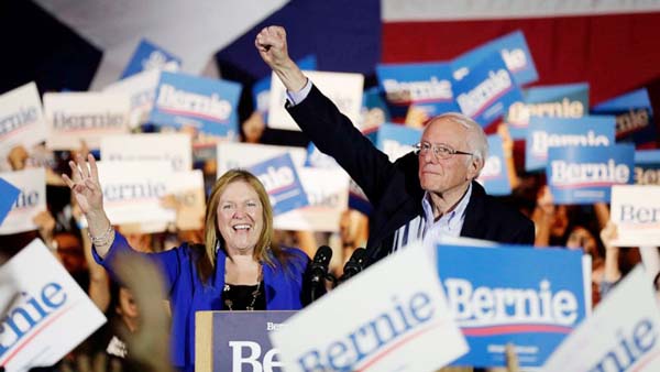 Democratic presidential candidate Sen. Bernie Sanders, I-Vt., right, with his wife Jane, raises his hand as he speaks during a campaign event in San Antonio, on Saturday.