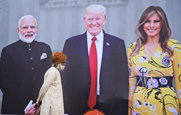 An elderly man walks past a giant hoarding welcoming U.S. President Donald Trump in Agra, India on Sunday. Trump and the First Lady Melania Trump will be visiting Taj Mahal during their visit two-day trip to India.