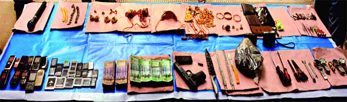 DB police arrested one criminal raided a house in city's Pallabi and recovered stolen materials including gold ornaments, mobile phones, one pistol with a magazine including Taka 3 lakh 80 thousands. This photo was taken from DMP media centre on Sunday.