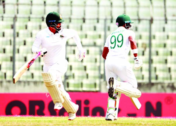 Tamim Iqbal (left) and Najmul Hossain Shanto running between wickets during the second day of the Lone Test match between Bangladesh Cricket team and Zimbabwe Cricket team at the Sher-e-Bangla National Cricket Stadium in the city's Mirpur on Sunday.