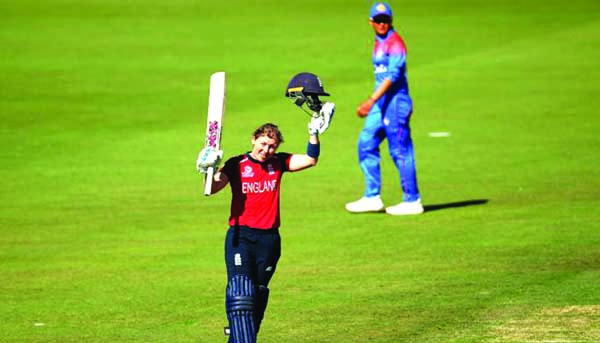 England skipper Heather Knight raises her bat after making 100 runs against Thailand during their Women's T20 World Cup match on Wednesday.