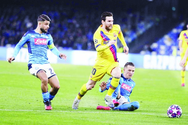 Barcelona's Lionel Messi (center) dribbles past Napoli's Piotr Zielinski (right) and Napoli's Lorenzo Insigne during the Champions League, Round of 16, first-leg soccer match between Napoli and Barcelona, at the San Paolo Stadium in Naples, Italy on Tu