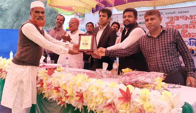 Zihad Bin Ali, President, School Management Committee and UP Chairman is being greeted by Md. Jamirul Islam, UNO at the prize giving ceremony of annual sports and cultural competition of Chotto Moheshkhali Adarsha High School in Cox's Bazar on