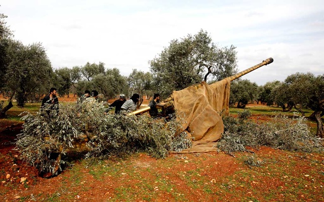Syrian fighters load an artillery near Idlib, Syria February 27, 2020. REUTERS
