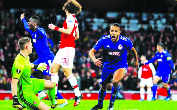 Olympiakos' Youssef El-Arabi celebrates his late goal against Arsenal in their UEFA Europa League match on Thursday.