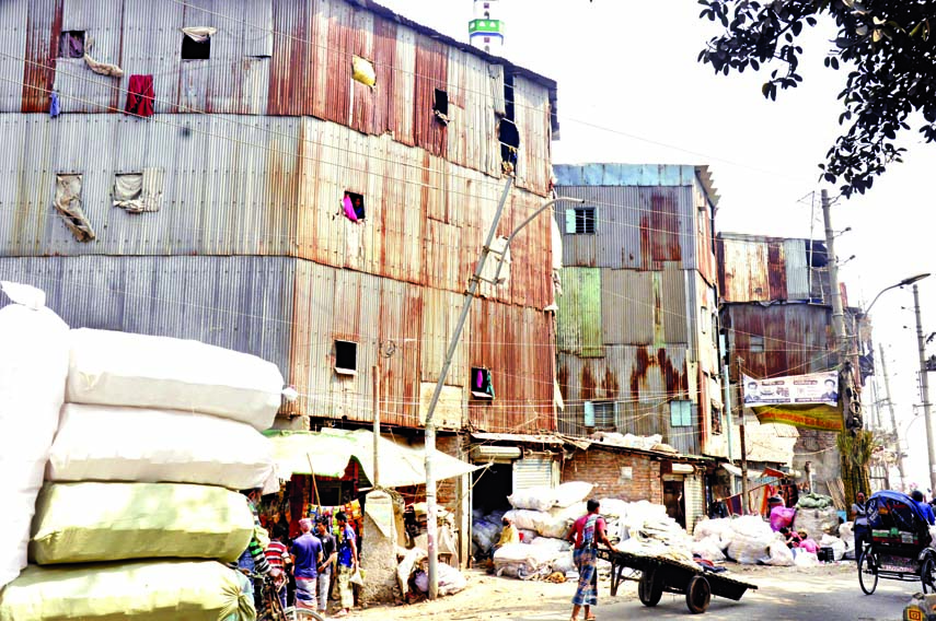Multi-storey tin-shed houses are being built at various areas in the capital where low-income group people living are at great risk. This photo was taken from Chawkbazar area on Friday.