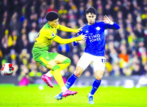 Norwich City's Jamal Lewis (left) and Leicester City's Ayoze Perez battle for the ball during the English Premier League soccer match at Carrow Road in Norwich on Friday.