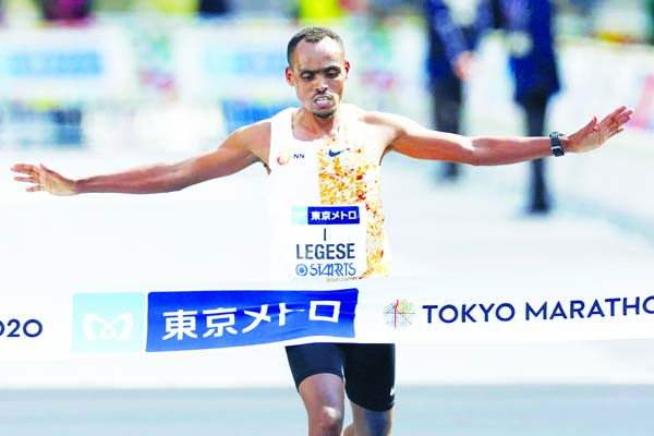 Ethiopia's Birhanu Legese crosses the finish line to win the Tokyo Marathon in Tokyo on Sunday. The race was scaled back as part of Japan's efforts to combat the spread of the coronavirus.