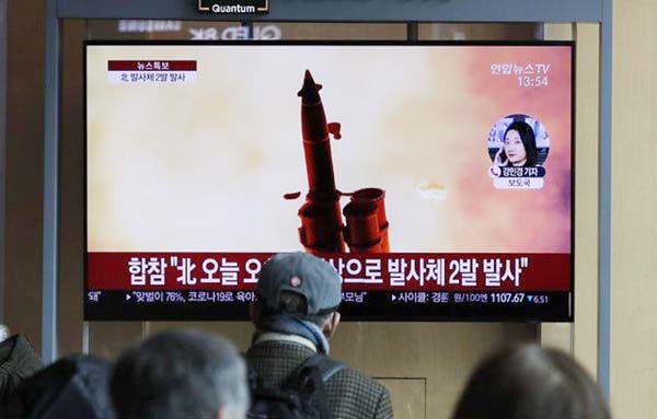 People at Seoul railway station watch a news programme about North Korea's firing of projectiles