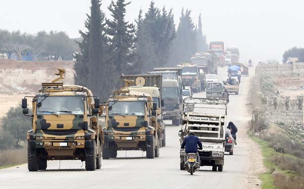 A Turkish military convoy moves in the east of Idlib, Syria. Syria's official news agency said on Sunday that two of its warplane were shot down by Turkish forces inside northwest Syria, amid a military escalation there that's led to growing direct clas
