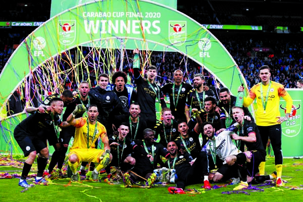 Manchester City players celebrate winning the League Cup soccer match final with a 2-1 score against Aston Villa, at Wembley stadium in London on Sunday.