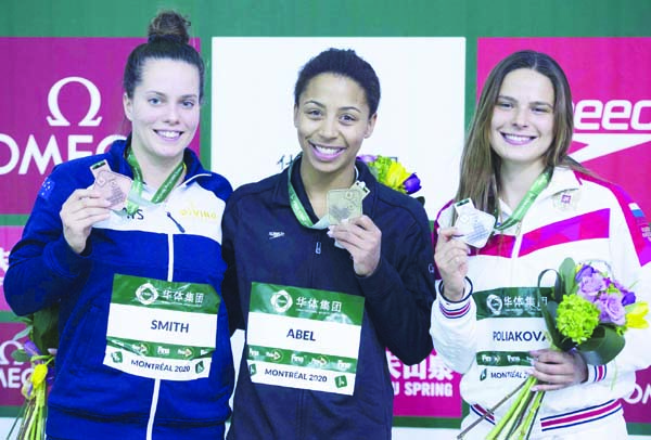 Bronze medallist Anabelle Smith of Australia (left) gold medallist Jennifer Abel of Canada (center) and silver medallist Maria Poliakova of Russia hold up their medals following the women's 3-meter springboard final at the FINA Diving World Series in M