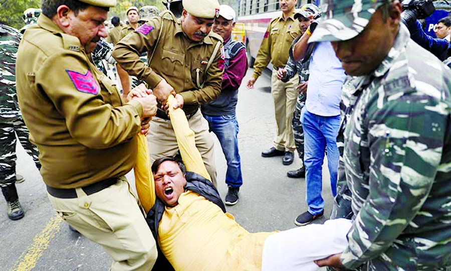 Police detain Congress party workers during a protest against last week's deadly communal riots in Delhi, on Monday.