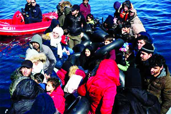 Migrants, who crossed part of the Aegean Sea from Turkey, are seen on a dinghy with a damaged engine, as locals prevent them from docking at the port of Thermi on island of Lesbos.