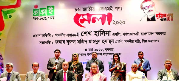 Prime Minister Sheikh Hasina poses for a photo session after handing over "National SME Entrepreneurs Award-2020" among two female and three male entrepreneurs at inaugural ceremony of a nine-day fair at the Krishibid Institution, Bangladesh (KIB) Audit