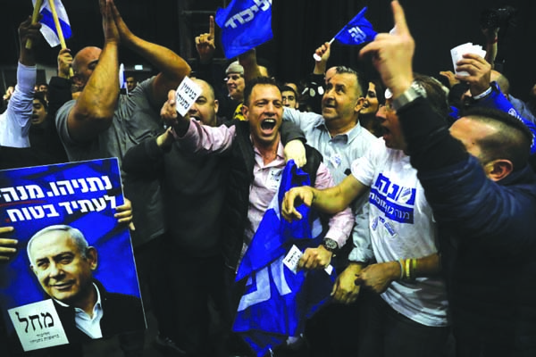 Israeli Prime Minister Benjamin Netanyahu's supporters celebrate first exit poll results for the Israeli elections at his party's headquarters in Tel Aviv, Israel on Monday.