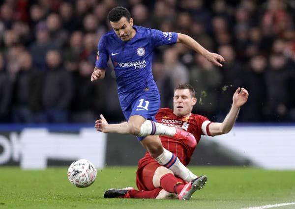 Chelsea's Pedro (left) is tackled by Liverpool's James Milner during the English FA Cup fifth round soccer match between Chelsea and Liverpool at Stamford Bridge stadium in London on Tuesday.