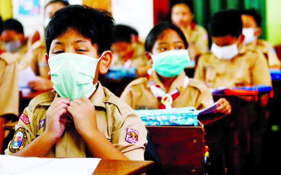 Students wear protective masks in school after Indonesia confirmed its first cases of COVID-19, in Jakarta, Indonesia, on Wednesday.