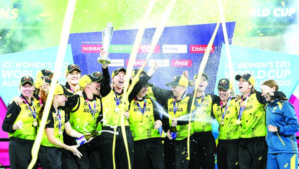 Australian players celebrate their win over India in the Women's T20 World Cup cricket final match in Melbourne on Sunday.