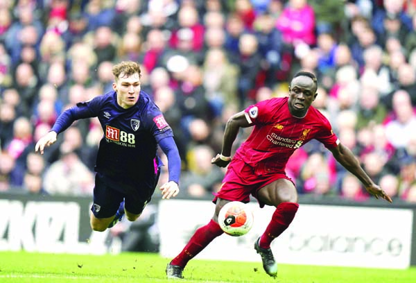 Liverpool's Sadio Mane (right) dribbles past Bournemouth's Jack Stacey during the English Premier League soccer match between Liverpool and Bournemouth at Anfield stadium in Liverpool of England on Saturday.