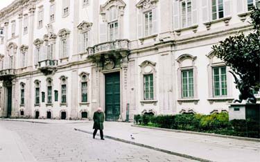A pedestrian in an almost empty street in Milan's city centre.