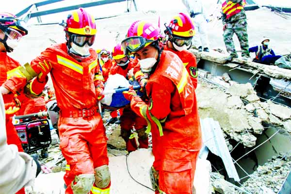 A man is rescued from the rubble of a collapsed hotel in Quanzhou where 71 people were held under observation for coronavirus.