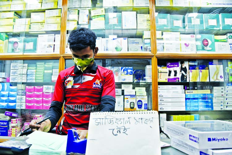 Drug stores across the capital ran out of masks and sanitisers amid a sudden spike in demand after the first cases of coronavirus infection in the country were reported on Sunday. This photo was taken on Monday shows a salesman wears protective mask at a