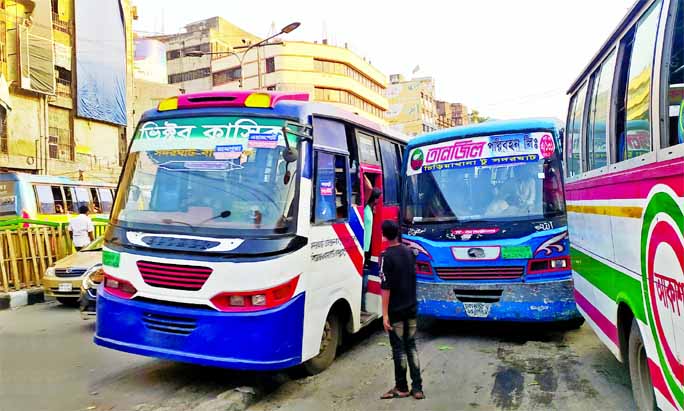 Two buses engaged in wild competition to overtake each other defying traffic rules amid alarming deterioration in Dhaka's traffic situation. This snap was taken from Gulistan intersection on Wednesday.