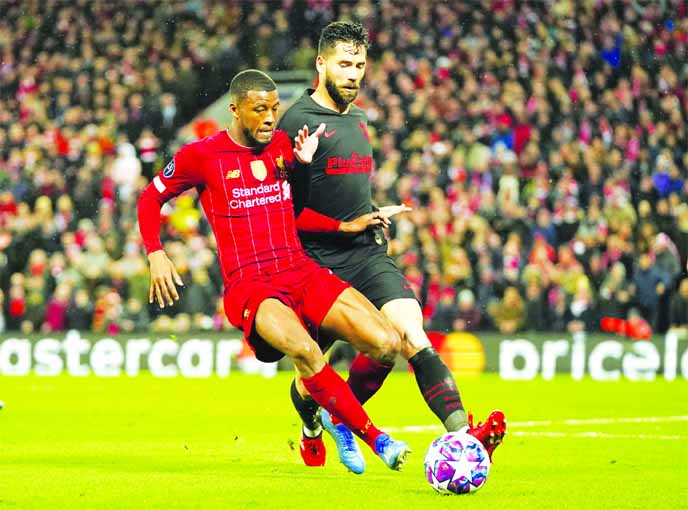 Liverpool's Georginio Wijnaldum (left) is challenged by Atletico Madrid's Felipe during a second leg, round of 16, Champions League soccer match between Liverpool and Atletico Madrid at Anfield stadium in Liverpool of England on Wednesday.