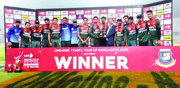 Players of Bangladesh Cricket team with the President of Bangladesh Cricket Board Nazmul Hassan Papon pose with the championship trophy of the Twenty20 International (T20I) cricket series after beating Zimbabwe in the second T20I at the Sher-e-Bang