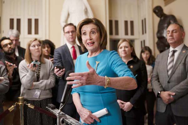 Speaker of the House Nancy Pelosi, D-Calif., makes a statement ahead of a planned late-night vote on the coronavirus aid package deal at the Capitol in Washington on Friday.
