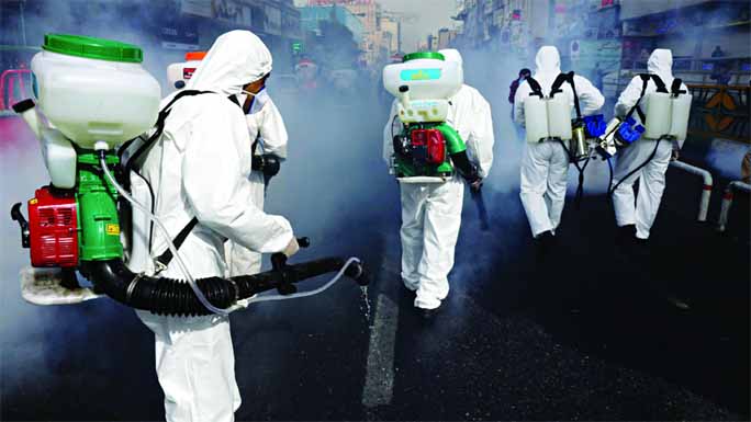 Firefighters disinfect a street against the new coronavirus, in western Tehran, Iran on Saturday.