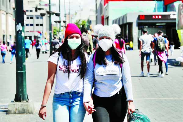 Women wear protective masks in response to the spreading coronavirus in Caracas, Venezuela.