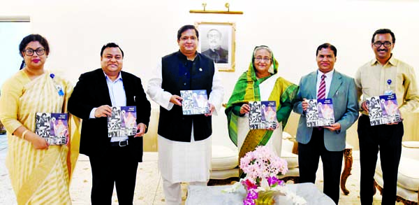 Prime Minister Sheikh Hasina along with others holds the copies of a book titled 'Kriranuragi Bangabandhu Paribar' at its cover unwrapping ceremony at her office on Monday. PID photo