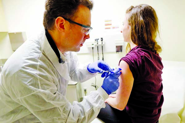 A pharmacist administered a shot in the first stage of a clinical trial for a potential vaccine for the coronavirus at Kaiser Permanente Washington Health Research Institute in Seattle on Monday. Internet photo
