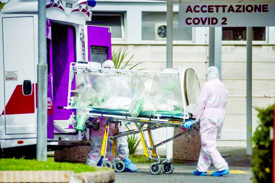 Medical staff collect a patient from an ambulance at the second COVID-19 hospital in the Columbus unit in Rome, Italy.